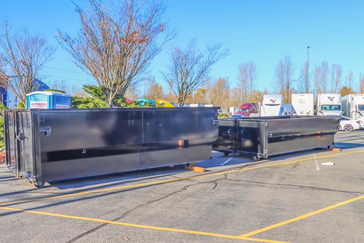 Professional dumpster rental service with roll-off container on residential driveway in Grayson Valley